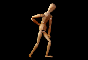 Wooden mannequin with arm on back